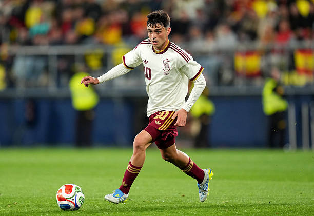 Pedri in a white and maroon Spanish national team kit
